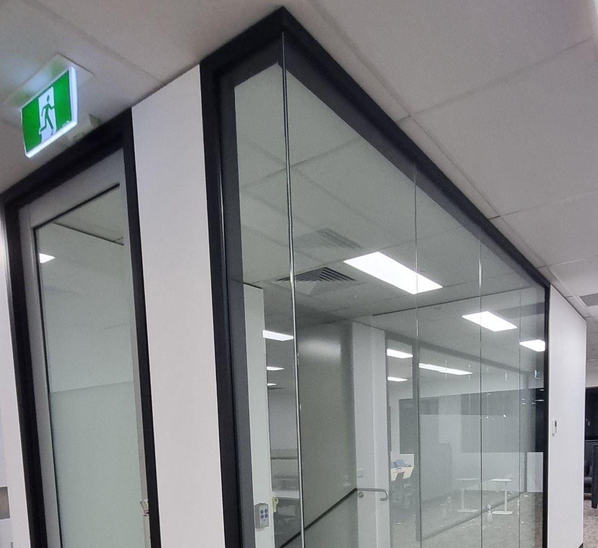 Office glass partitions and ceiling lights after a clean